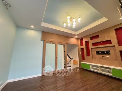 Spacious modern living room with stylish ceiling lights and built-in entertainment unit.