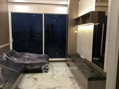 Luxurious living room with marble flooring and city view from large window.