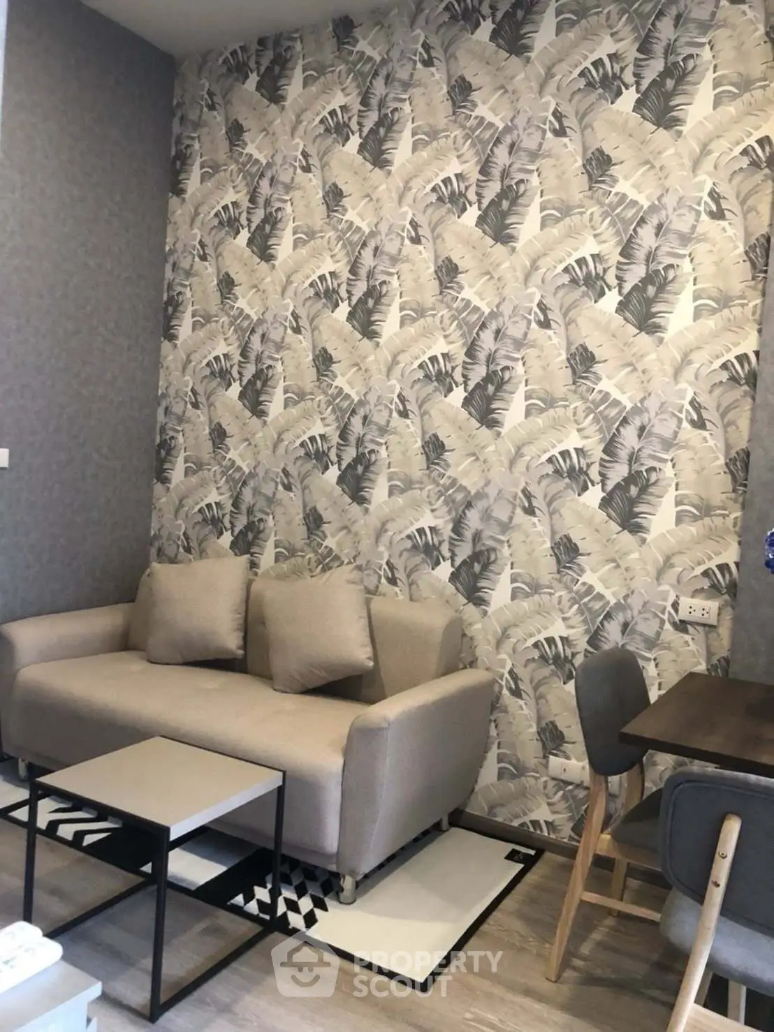 Stylish living room with modern wallpaper and cozy furniture in a contemporary apartment.