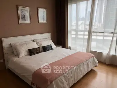 Elegant bedroom with large window and stylish decor in modern apartment