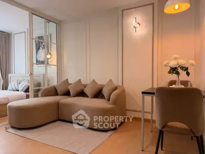 Modern living room with stylish beige sofa and cozy dining area