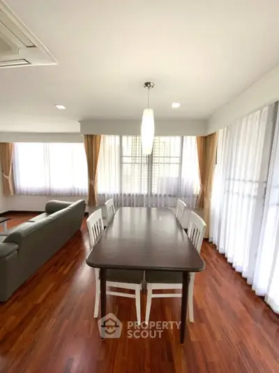 Spacious living room with elegant dining area and natural light