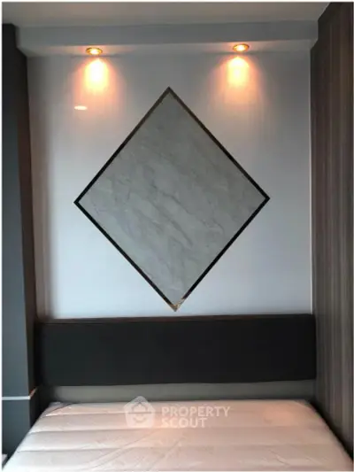 Modern bedroom with stylish wall decor and ambient lighting