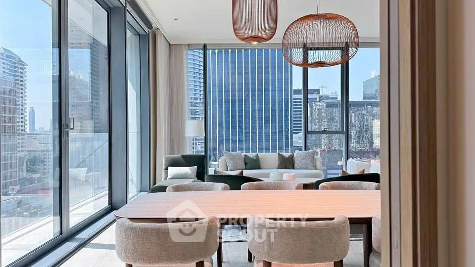 Luxurious modern living room with panoramic city views and elegant furnishings.