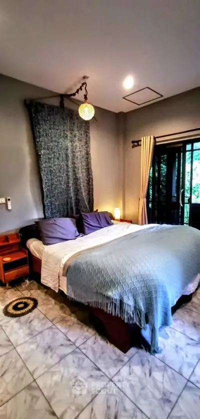 Cozy bedroom with elegant decor and natural light from large window