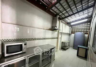 Spacious kitchen with modern appliances and ample storage in a well-lit area.