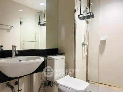 Modern bathroom with sleek fixtures and glass shower enclosure