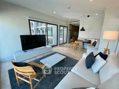 Modern living room with stylish furniture and large windows in a contemporary apartment.