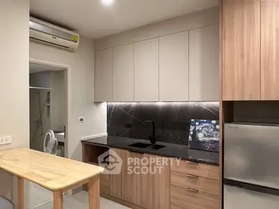 Modern kitchen with sleek cabinetry and integrated appliances in a stylish apartment.