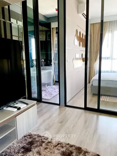 Modern apartment interior with stylish bedroom and living area, featuring sleek design and natural light.