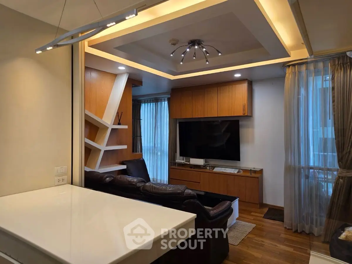 Modern living room with stylish lighting and built-in wooden shelves