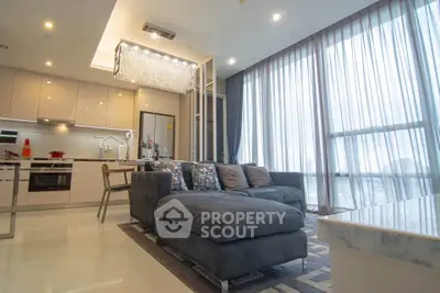 Luxurious modern living room with elegant chandelier and floor-to-ceiling windows