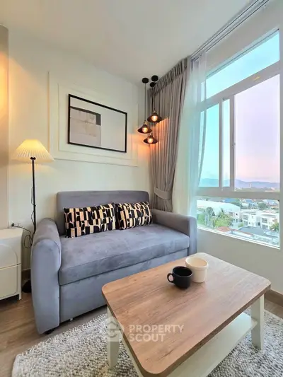 Chic living room with cozy sofa, stylish lighting, and scenic window view