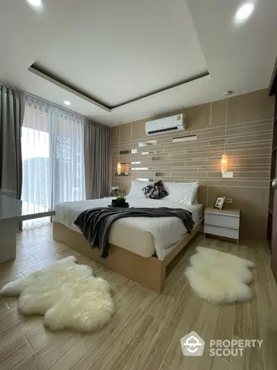 Luxurious bedroom with modern decor and cozy lighting, featuring stylish wooden flooring and elegant curtains.