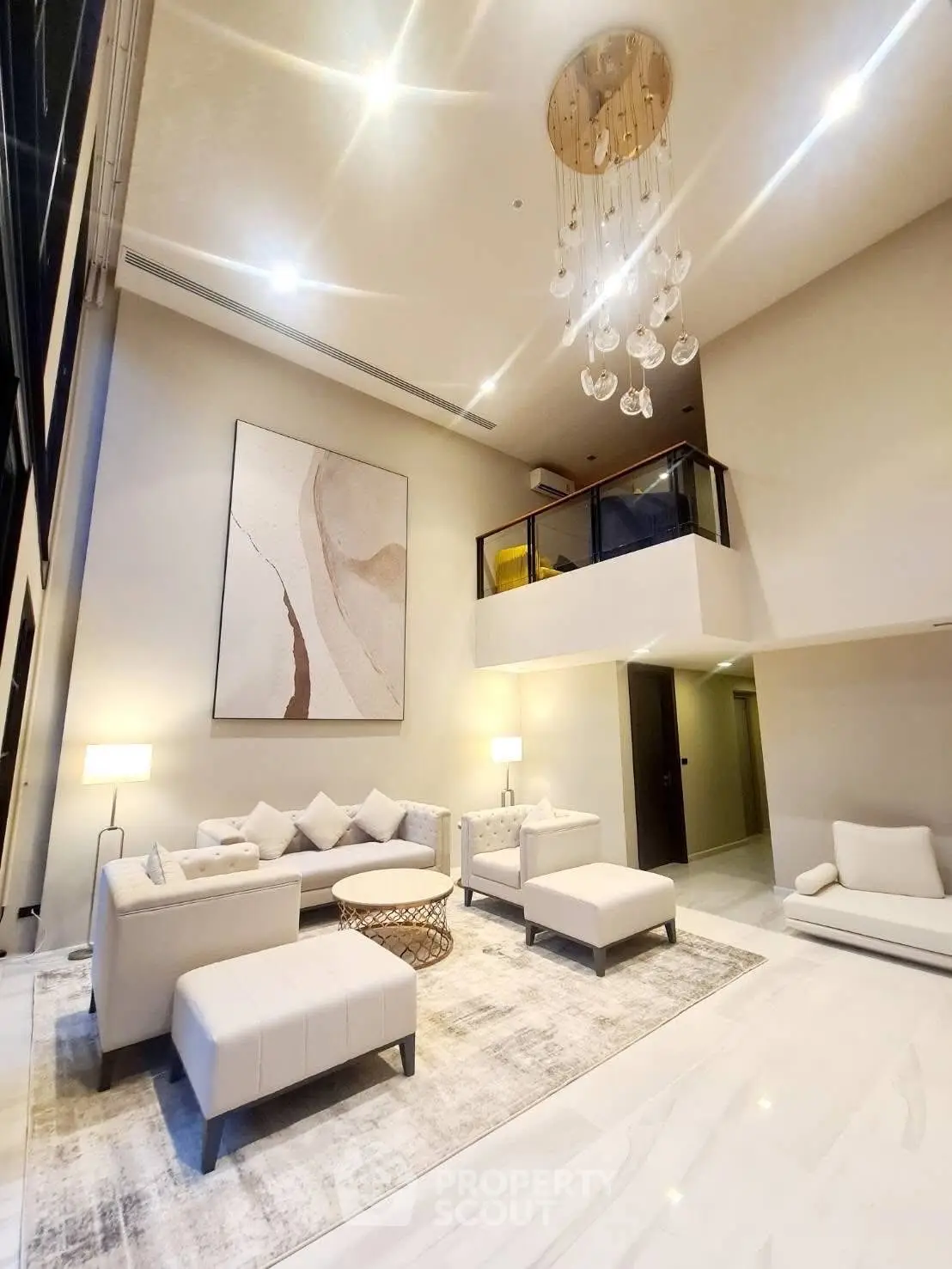 Luxurious modern living room with high ceilings and elegant chandelier