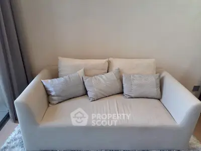 Elegant beige sofa with plush cushions in a modern living room setting