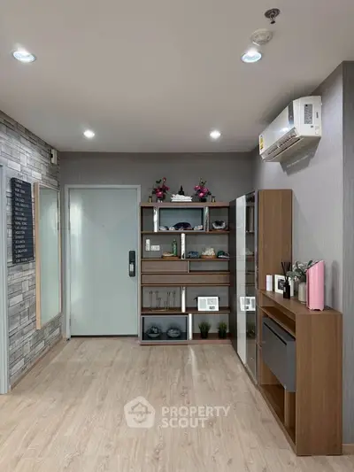 Modern interior with stylish shelving and air conditioning in a cozy living space.