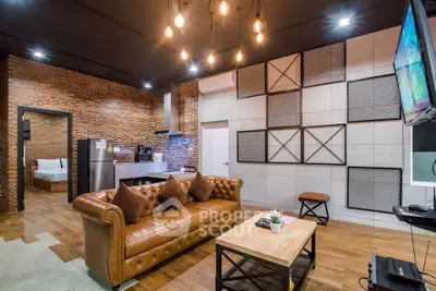 Stylish modern living room with leather sofa and industrial decor
