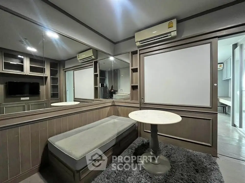 Modern living room with built-in seating and air conditioning, featuring sleek wood paneling and a cozy atmosphere.