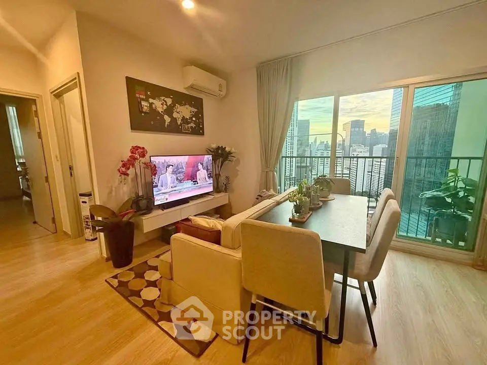 Modern living room with city view balcony, stylish decor, and cozy seating area.