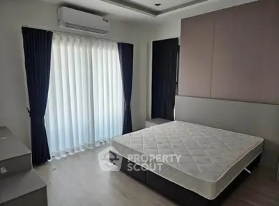 Modern bedroom with large window and minimalist design