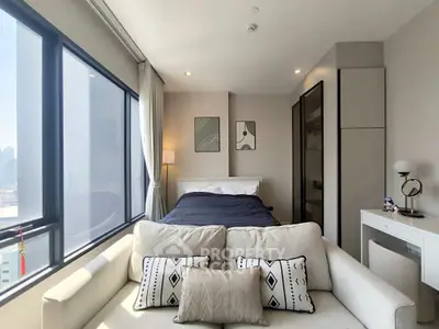 Modern bedroom with large windows and stylish decor in urban apartment