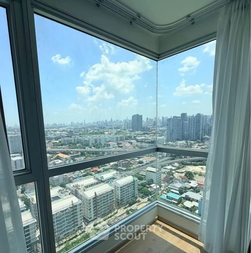 Stunning corner unit with panoramic city skyline view from high-rise apartment.