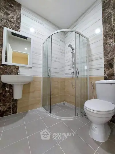 Modern bathroom with glass shower and elegant tile design