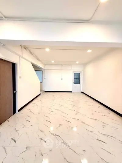 Spacious modern living room with marble flooring and bright lighting