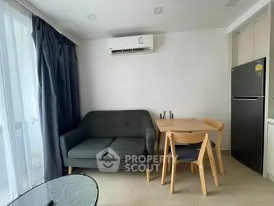 Cozy living area with modern furniture and air conditioning in a bright apartment.