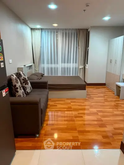 Modern studio apartment with wooden flooring and cozy furnishings