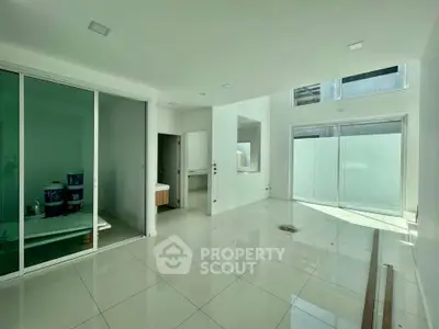 Spacious modern interior with large windows and sleek tile flooring