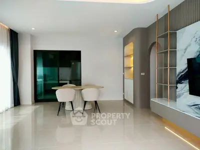 Modern living room with sleek design and open kitchen layout