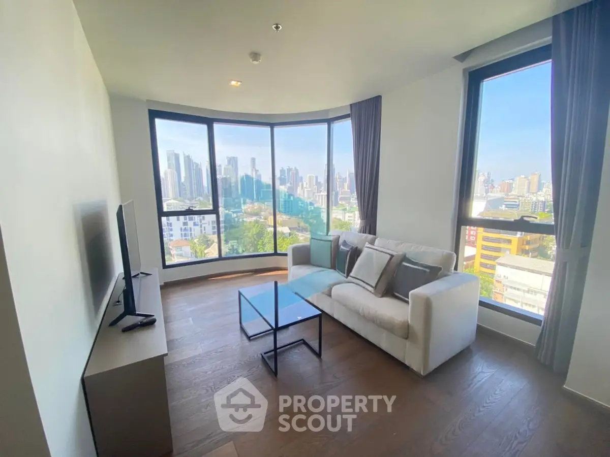 Spacious living room with panoramic city view and modern furnishings
