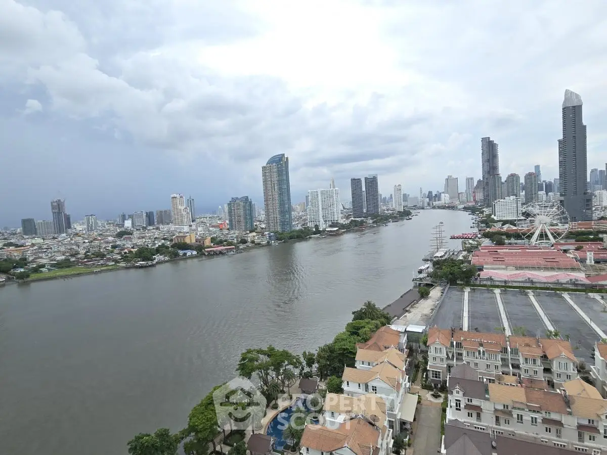 Stunning river view from high-rise apartment overlooking city skyline and residential area.