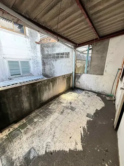 Spacious outdoor balcony with potential for renovation in urban setting.