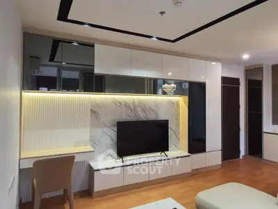 Modern living room with stylish TV unit and elegant lighting