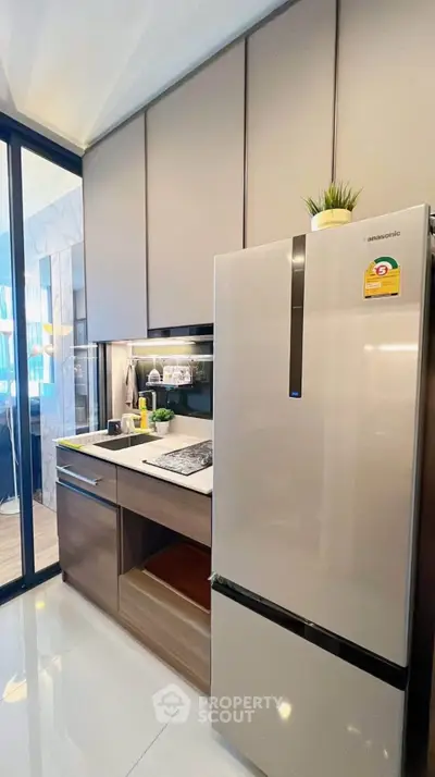 Modern kitchen with sleek cabinets and stainless steel fridge