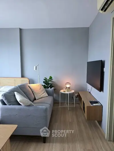 Modern living room with sleek furniture and wall-mounted TV, perfect for cozy relaxation.