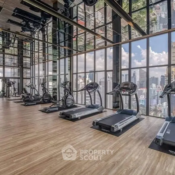 Luxurious high-rise gym with panoramic city views and modern fitness equipment.