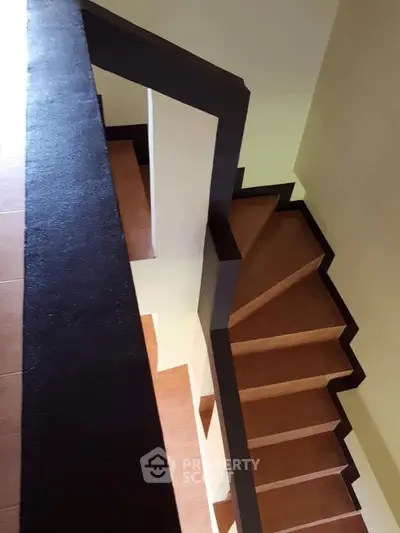 Modern staircase with sleek design and wooden steps in a contemporary home.