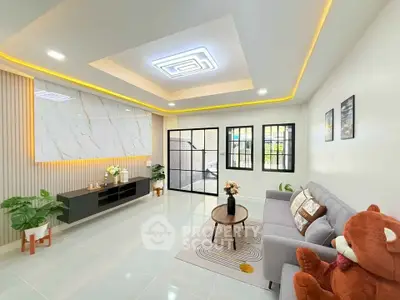 Modern living room with stylish decor and large teddy bear accent.