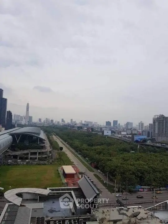 Stunning cityscape view from high-rise building overlooking lush green park and skyline.