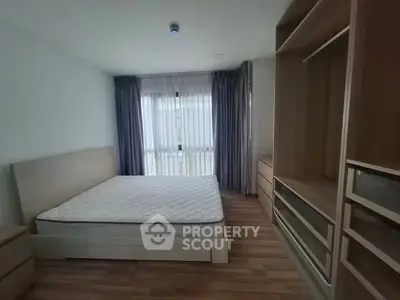 Spacious bedroom with modern furnishings and ample natural light