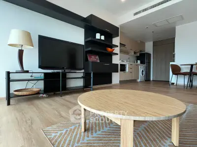 Modern living room with sleek furniture and open kitchen layout in a stylish apartment.