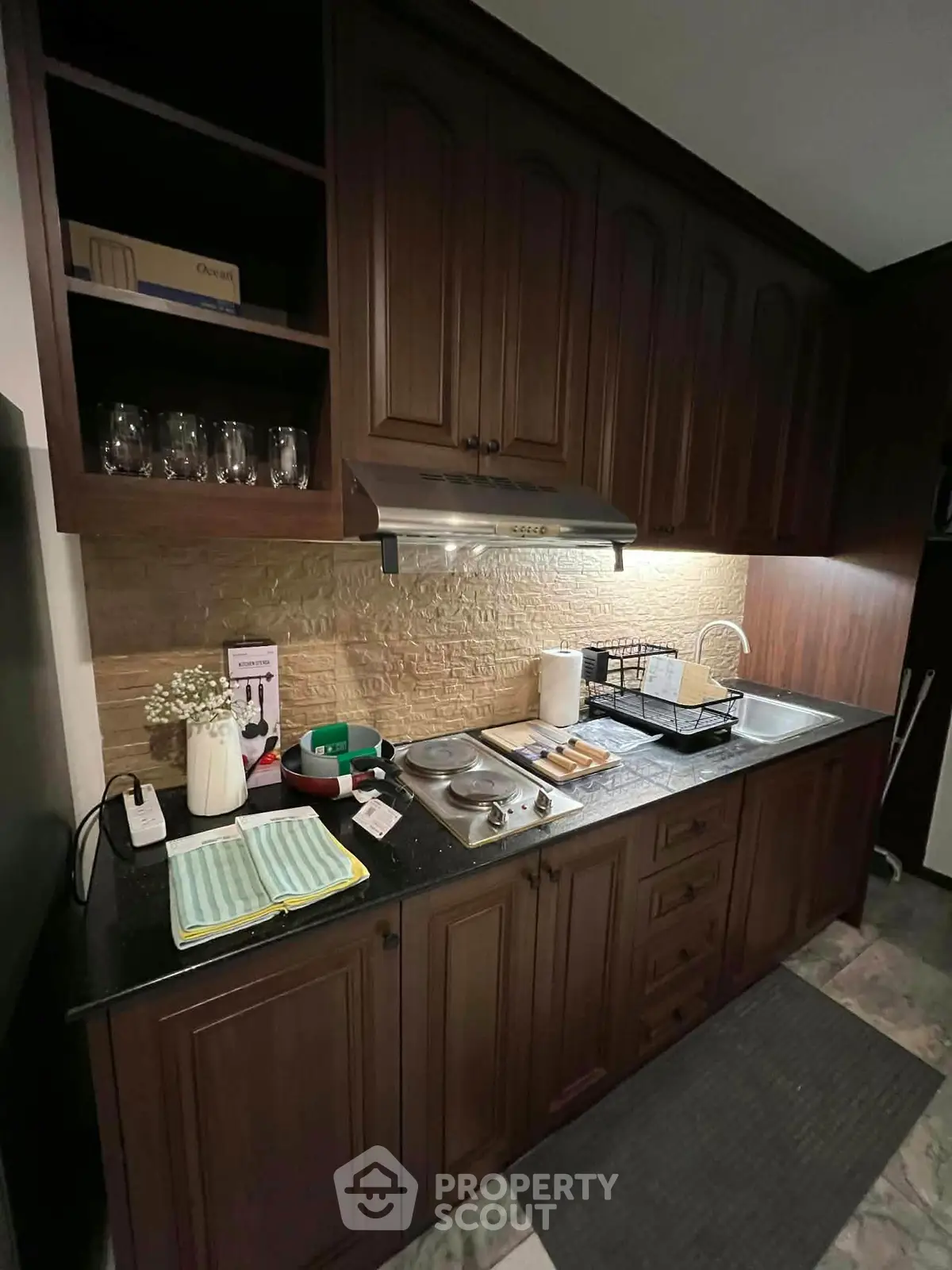 Charming kitchen with dark wood cabinets and modern appliances