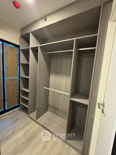 Spacious walk-in closet with modern wooden shelving and ample storage space