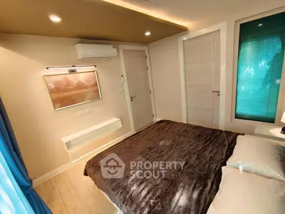 Modern bedroom with cozy decor and air conditioning in a stylish apartment.