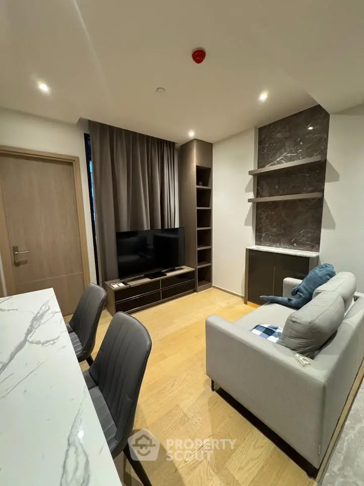 Modern living room with sleek furniture and marble accents