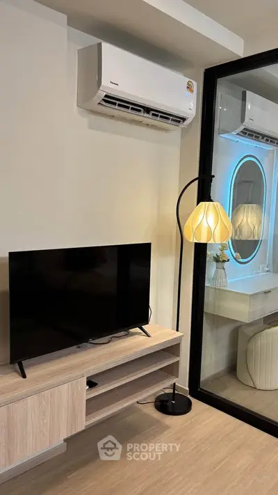 Modern living room with air conditioning and stylish floor lamp